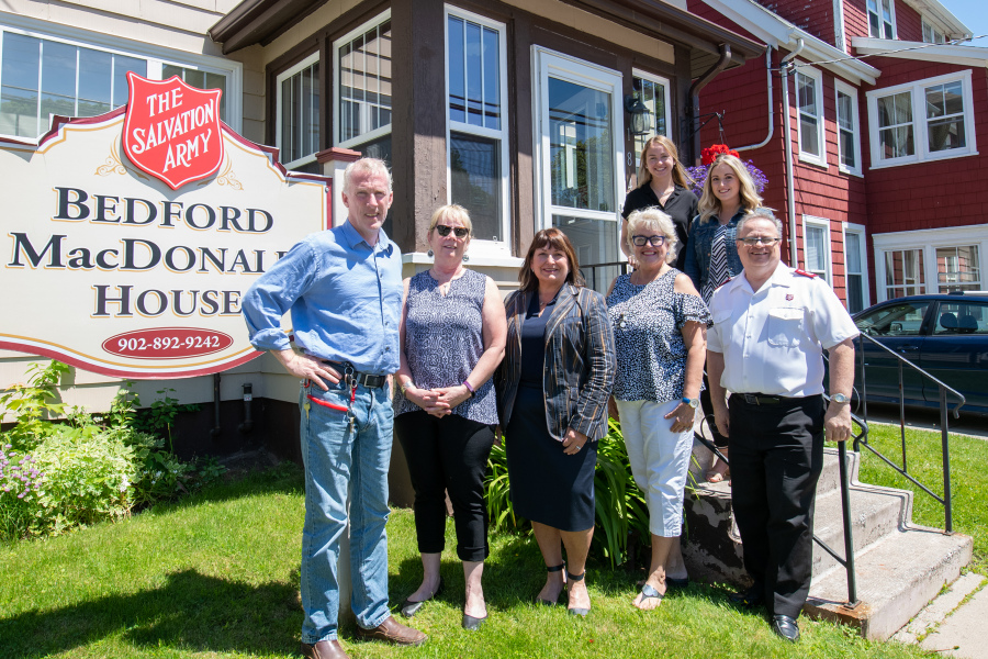 People stand in front of Bedford MacDonald House