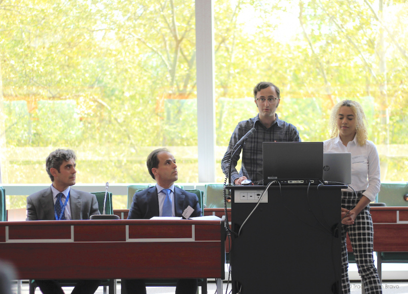 UPEI MGA students Michel Pass and Claire Byrne speak at a podium