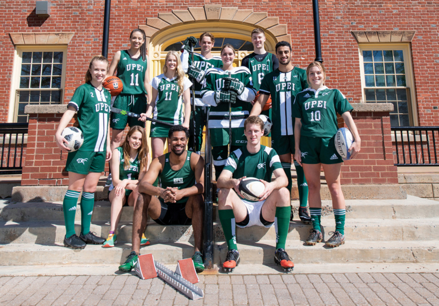 Several athletes from various sports pose on a set of stairs