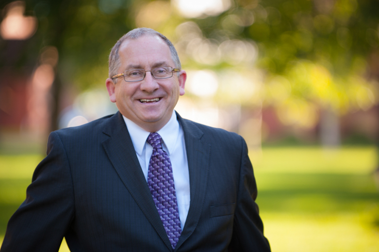 A smiling man in a suit