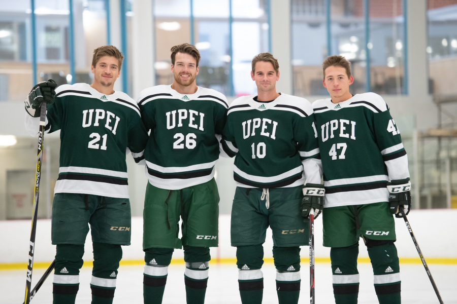 Four male hockey players