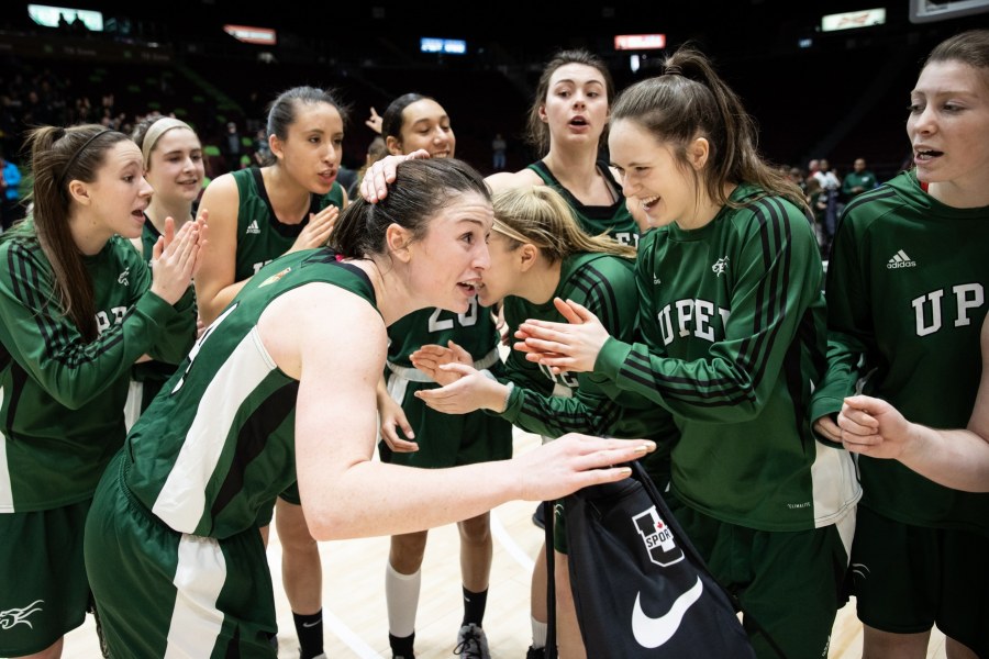 A group of female basketball players congratulating each other after a game