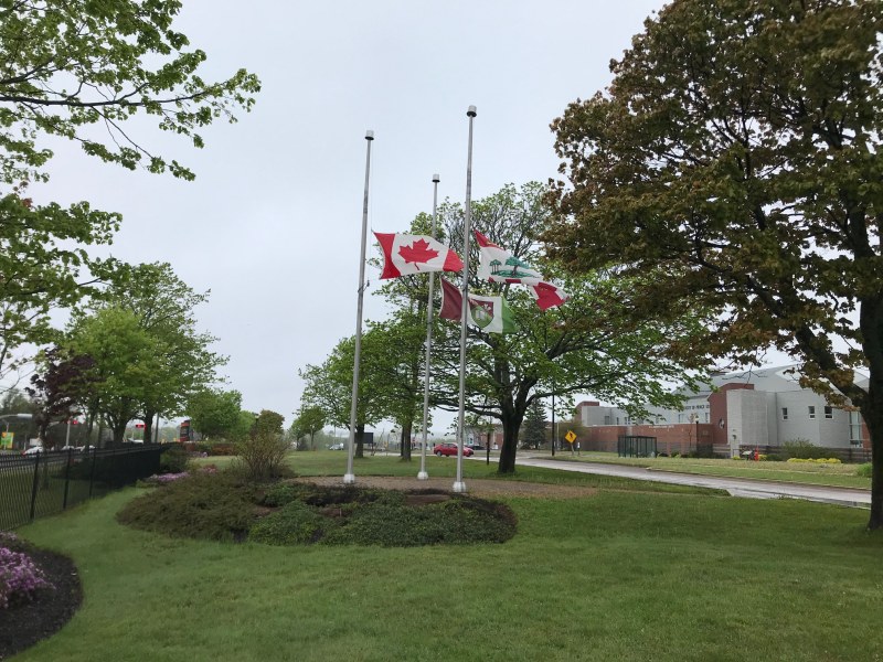 Image of the flags in front of Kelley Memorial Building at half mast