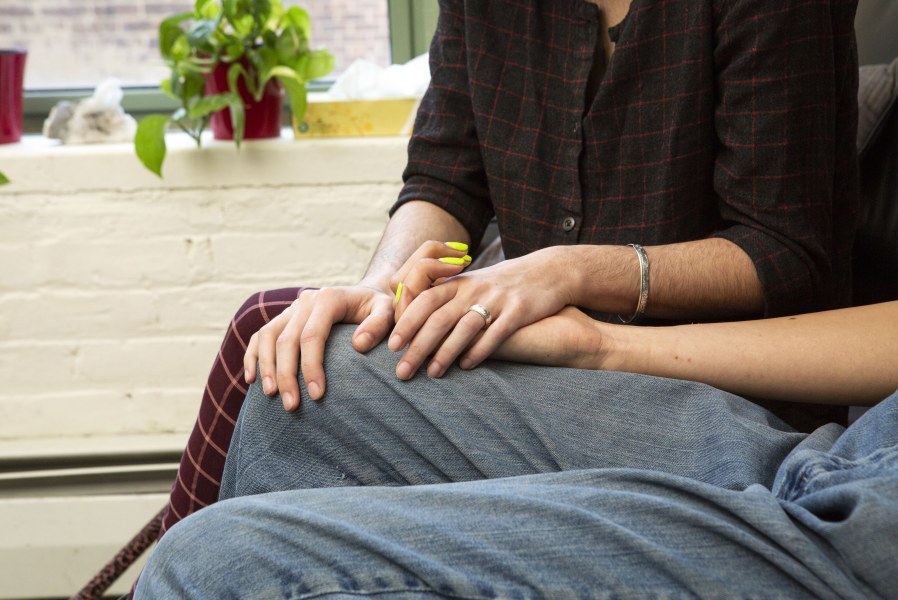 Couple sitting next to each other holding hands