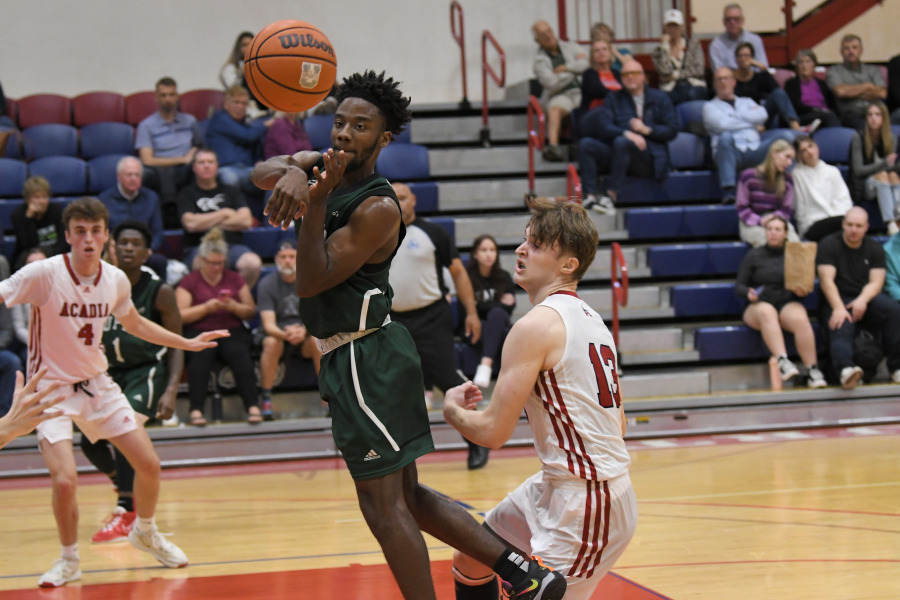 UPEI Men’s Basketball Panther Elijah Miller attempts a pass in a November 5 game against the Acadia Axemen.