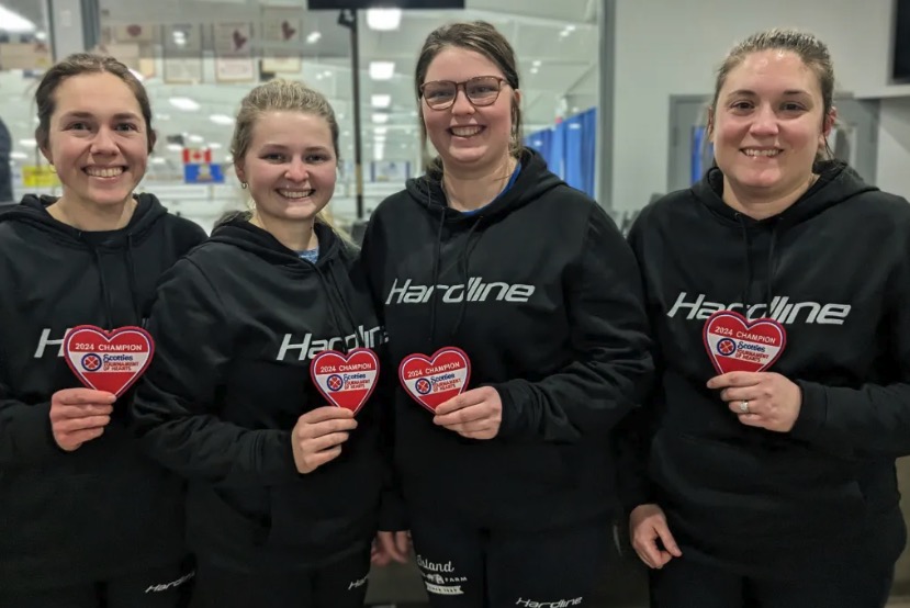 photo of four women holding heart patches