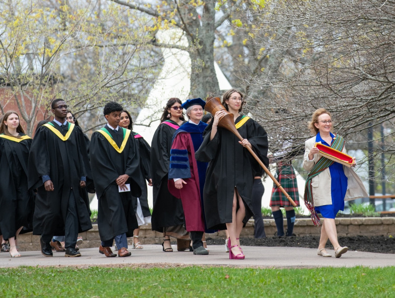 Marshal, Sue Dawson; Macebearer, Shanelle Berthier, Faculty of Science; and Eagle Feather Bearer, Erin Reid, assistant professor, Faculty of Indigenous Knowledge, Education, Research, and Applied Studies, lead graduates in the Faculty of Science into the Chi-Wan Young Sports Centre for their Convocation ceremony on May 16. Marshal, Sue Dawson; Macebearer, Shanelle Berthier, Faculty of Science; and Eagle Feather Bearer, Erin Reid, assistant professor, Faculty of Indigenous Knowledge, Education, Research, and Applied Studies, lead graduates in the Faculty of Science into the Chi-Wan Young Sports Centre for their Convocation ceremony on May 16.