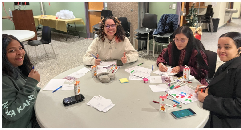 Students creating UPEI holiday cards in 2024.