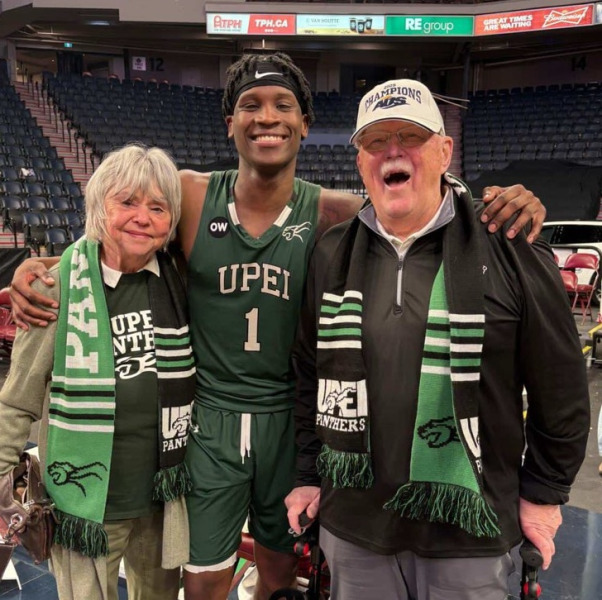 Marg and Steve Connolly celebrate UPEI’s 2025 AUS championship with Kamari Scott.