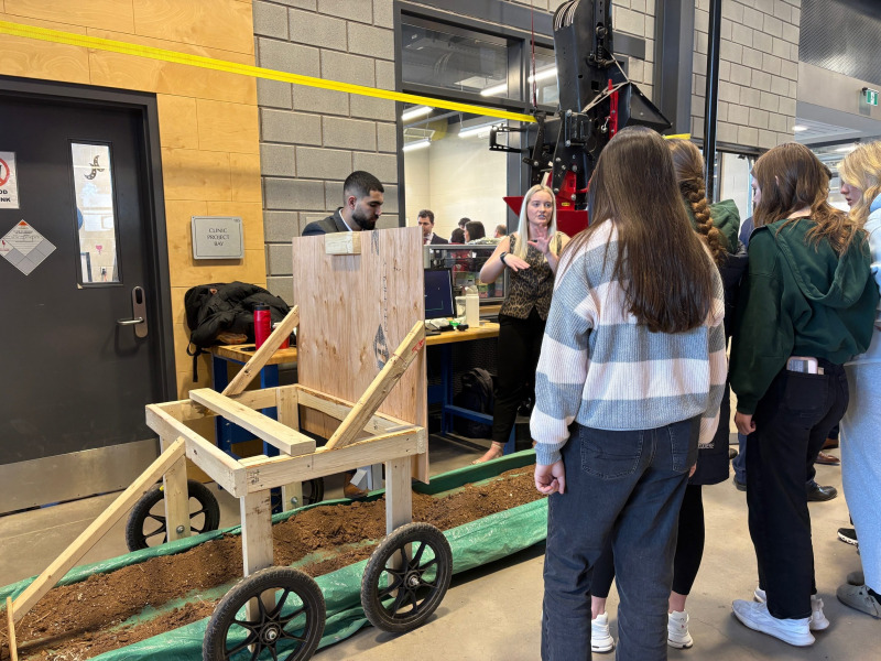 Woman describing equipment to a group of women students