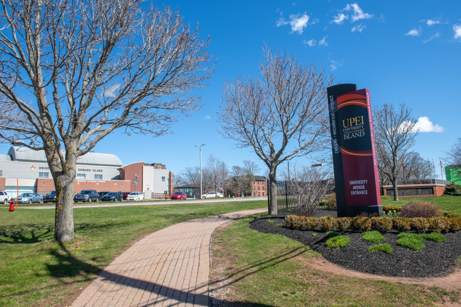 photo of sign in front of campus during spring
