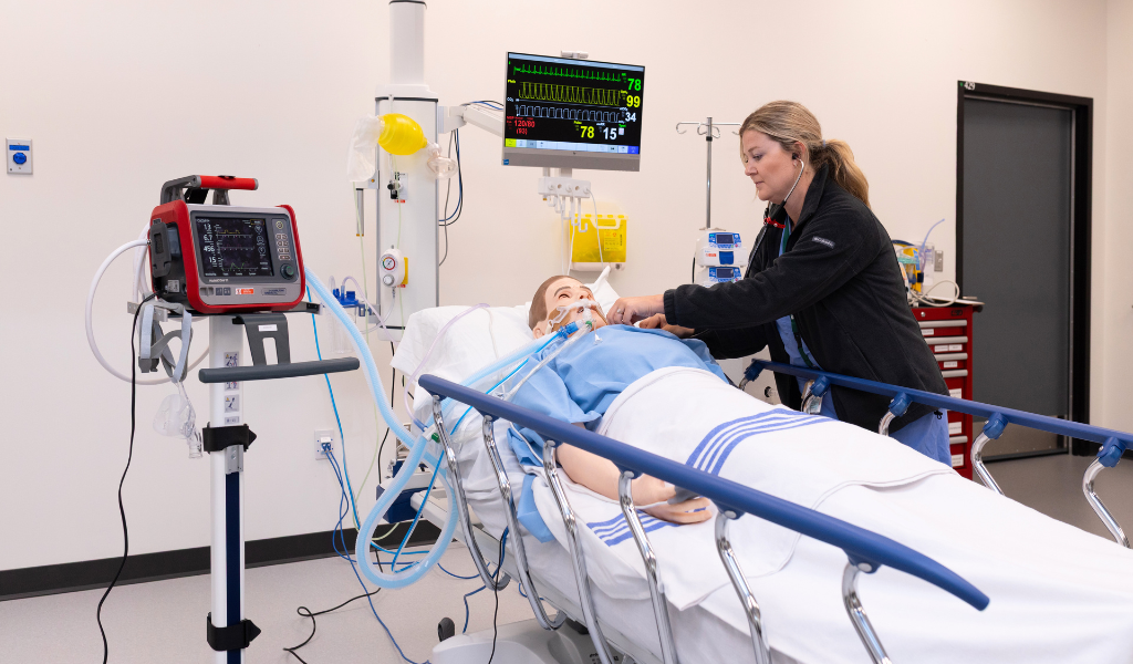 Jaclyn Sanderson, Simulation Program Assistant Manager, performs a simulation on a manikin in the Clinical Learning and Simulation Centre