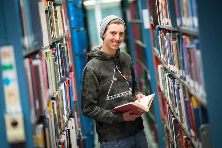 Caleb perusing the stacks.