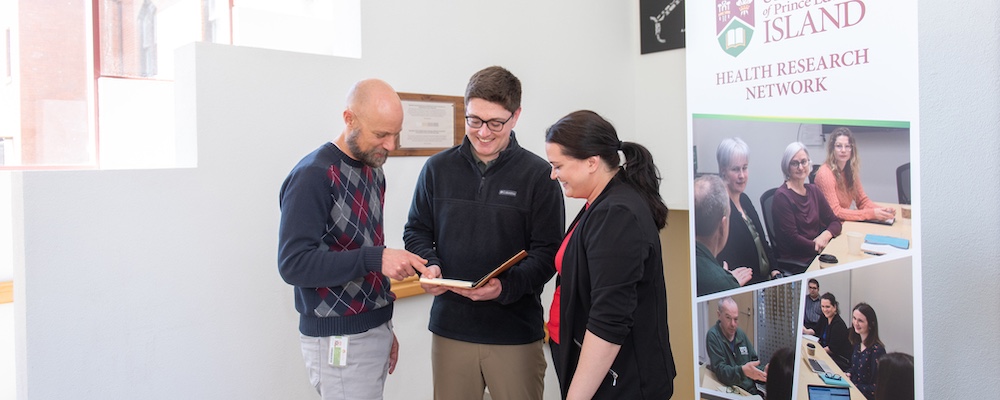 three people looking at a report