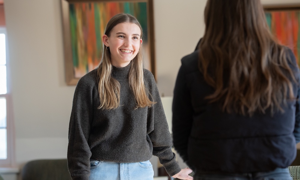 UPEI student Bella speaking with another student 