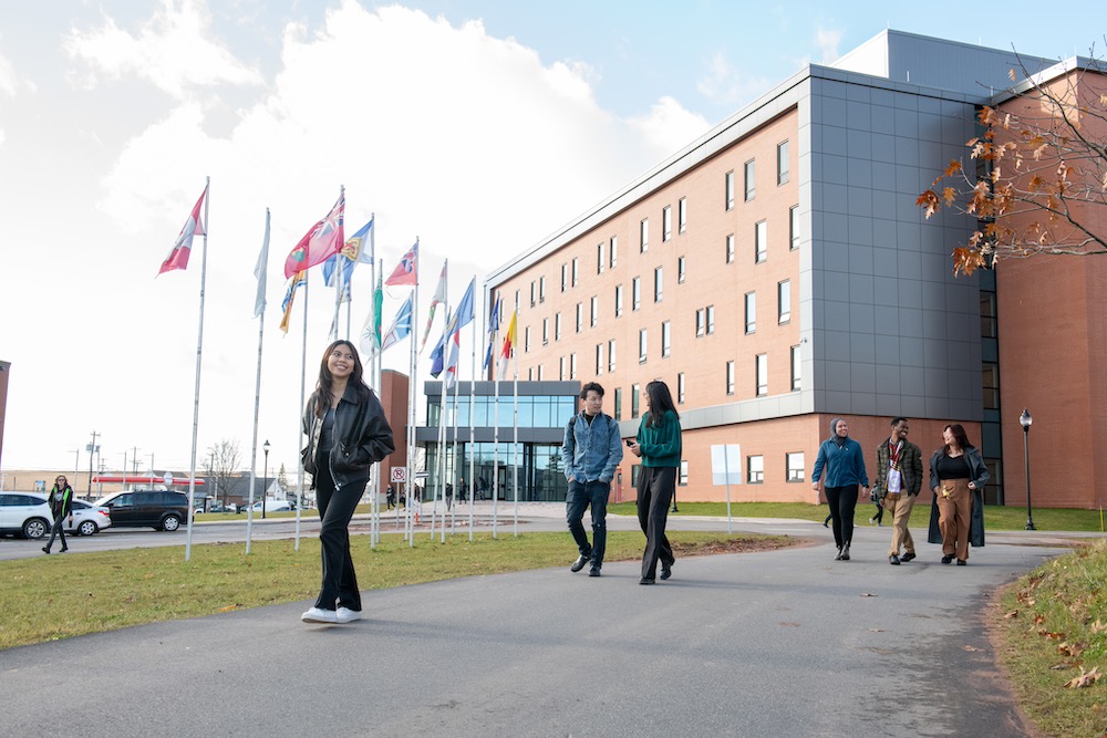 a group of students walking outside the Performing Arts Centre and Residence