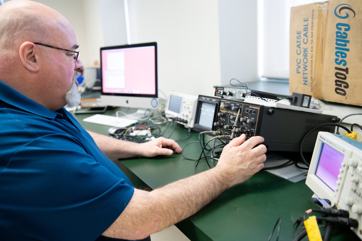 Chris Vessey using lab equipment