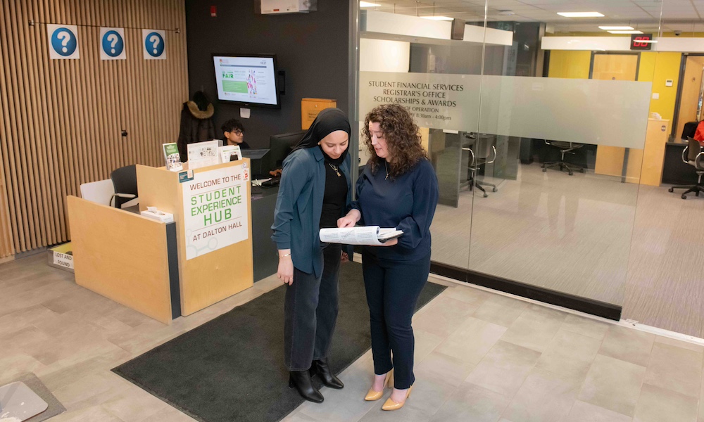 UPEI staff member Fairouz talking with a co-worker