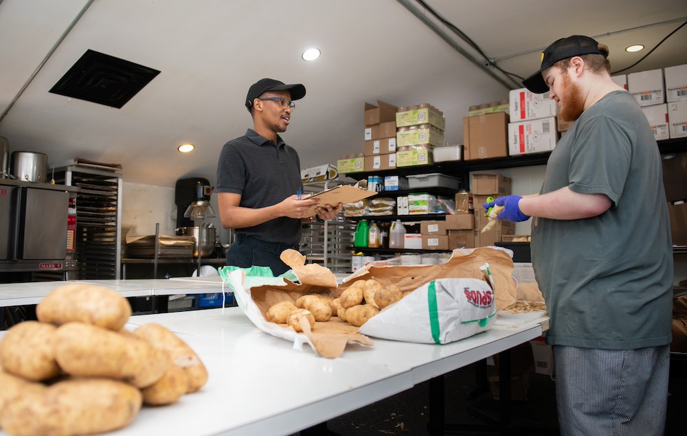 two men working in a restaurant kitchen