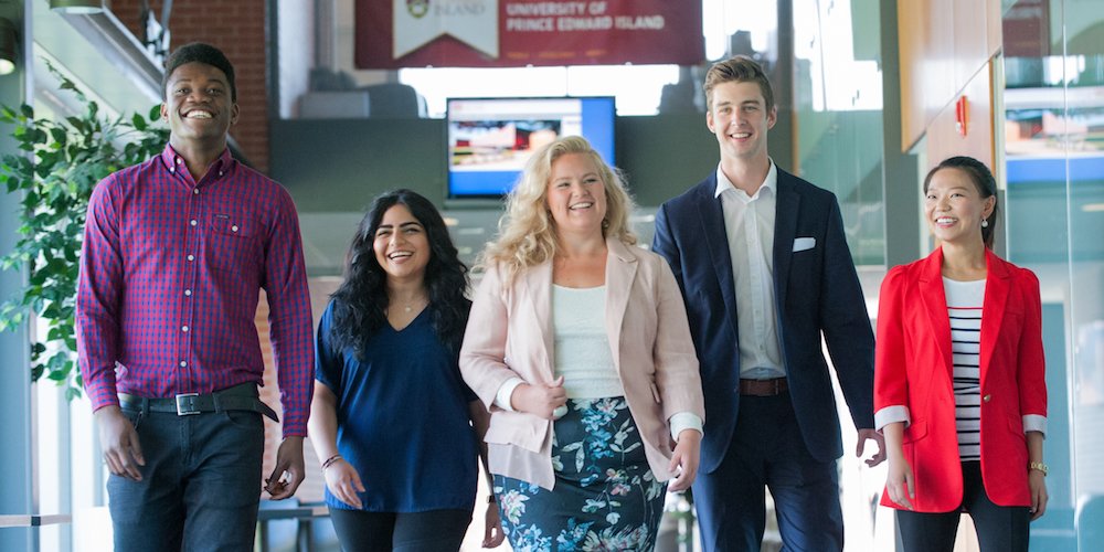 five business students walking in UPEI's McDougall Hall