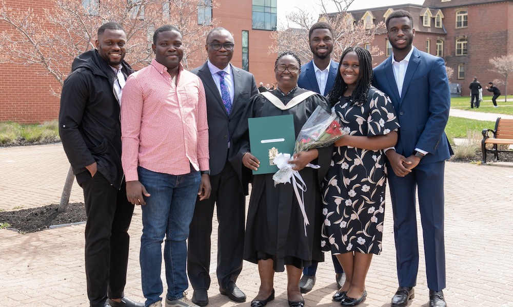 a student poses with her family at convocation