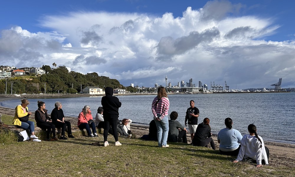 a group of students on a beach in New Zealand