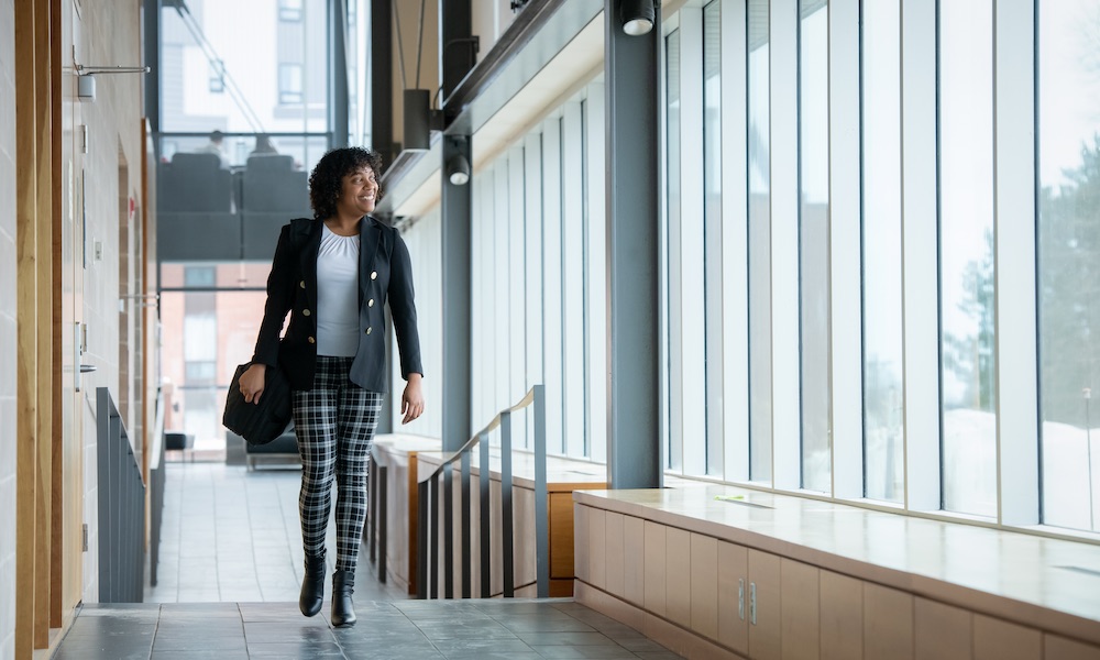 UPEI MBA in Global Leadership student Nathalie walking in the Faculty of Business building