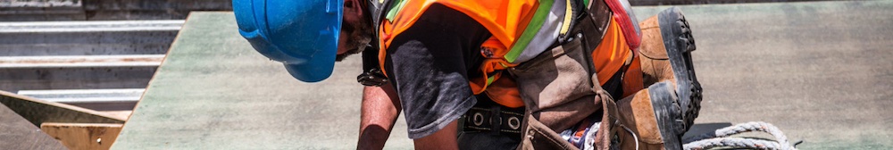 person wearing a safety vest with a hammer