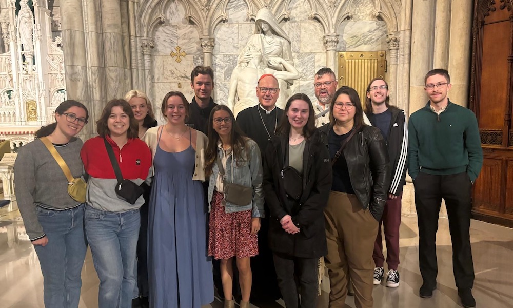 students with a clergy member in a church in New York