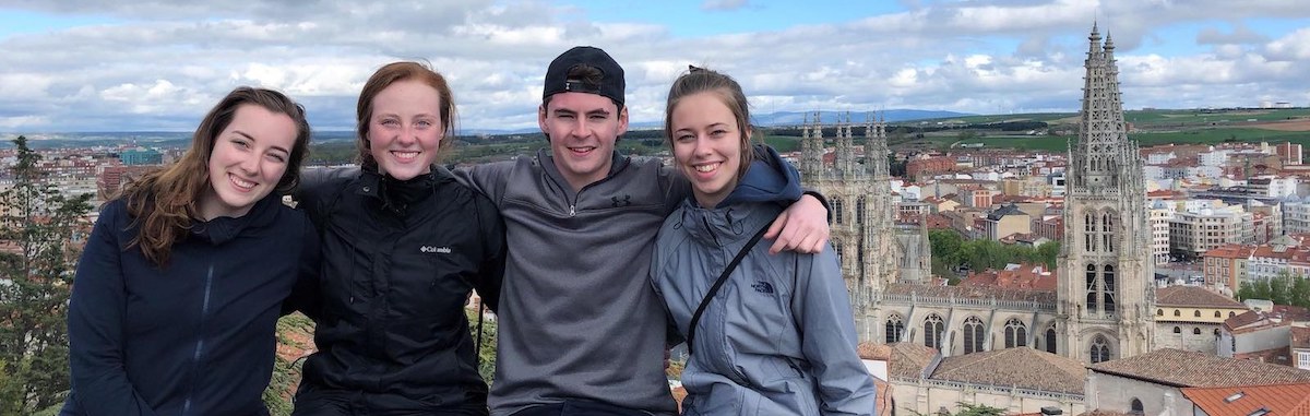 four UPEI students in burgos spain with the cathedral of saint mary of burgos in the background