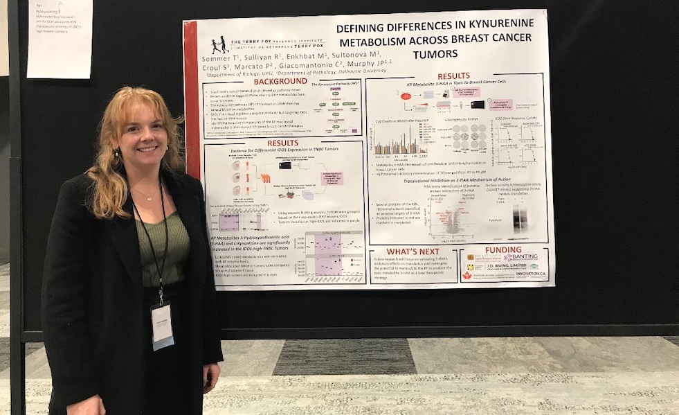 Tayah Sommer with a research poster