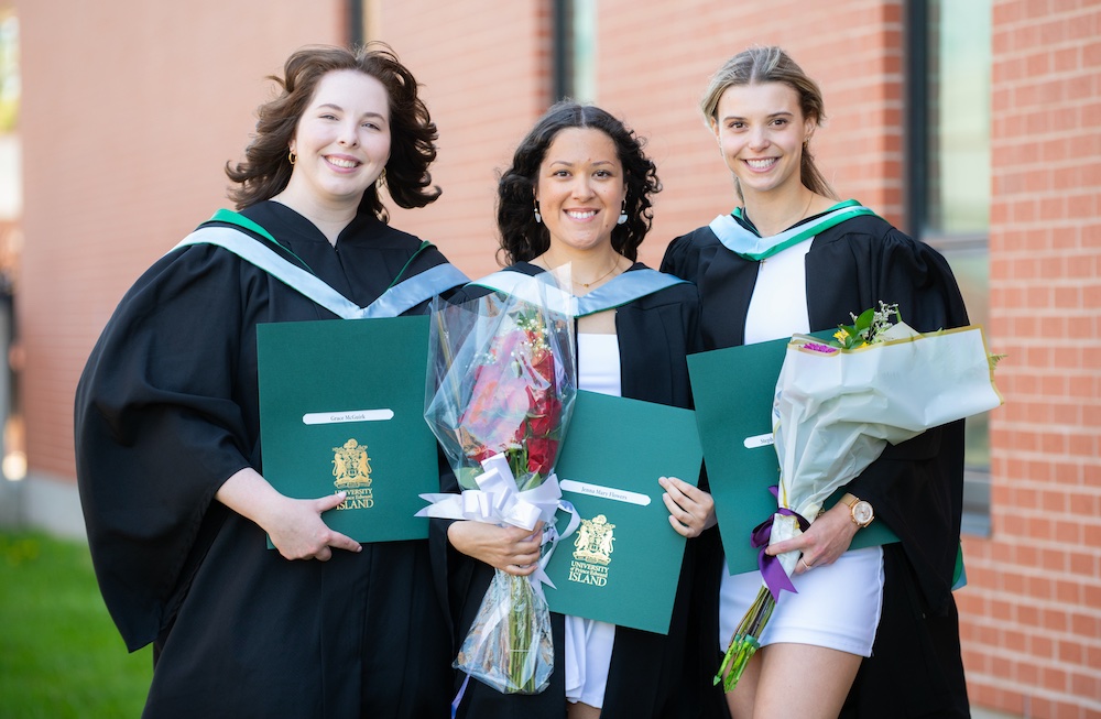 UPEI graduate Jenna Flowers and two classmates graduating at Convocation