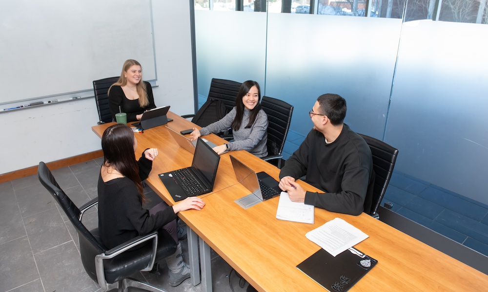 a group of four UPEI business students in McDougall Hall