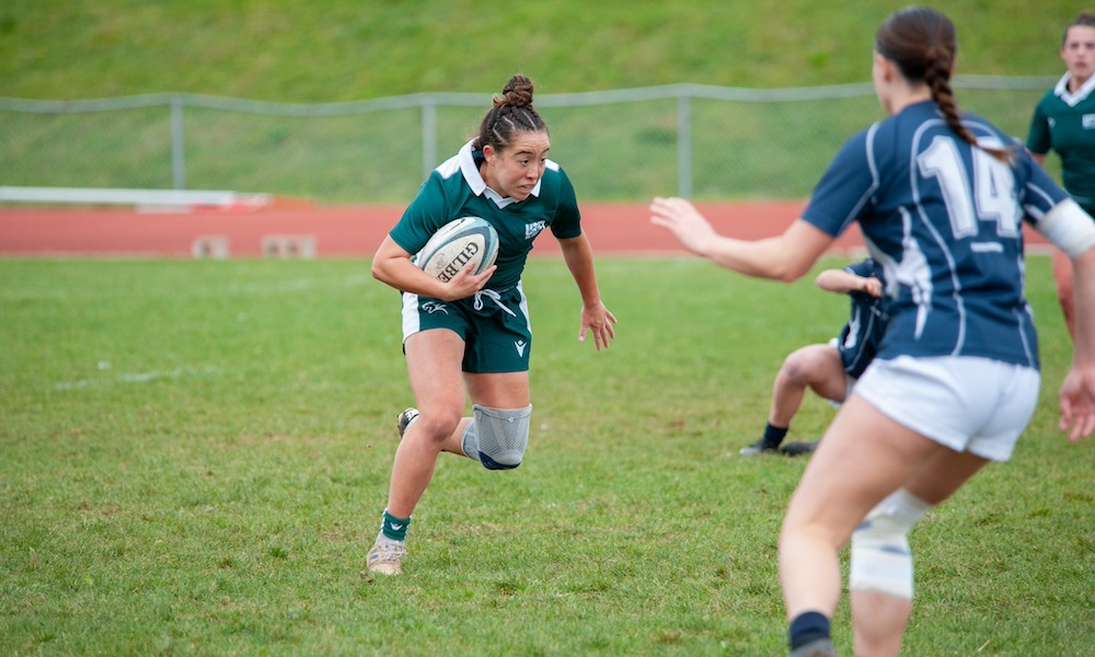 a UPEI rugby Panther running with a ball