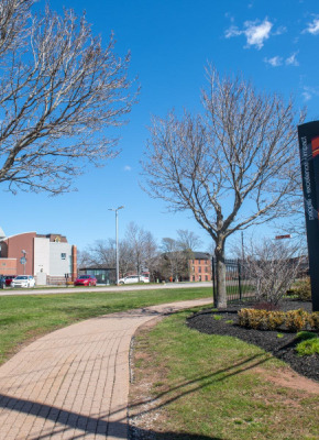 photo of sign in front of campus during spring