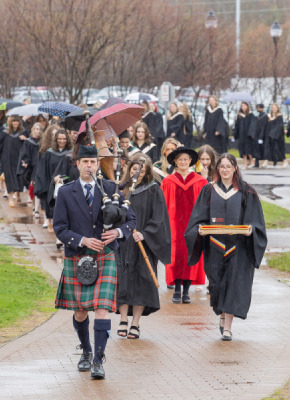 Graduates in the UPEI faculties of Nursing and Veterinary Medicine are led into the Chi-Wan Young Sports Centre for their Convocation ceremony on May 12 by Marshal Dr. Lisa Chilton; Macebearer Dr. Laura Groves, Faculty of Veterinary Medicine; and Eagle Feather Bearer Andrea Gallant, Faculty of Nursing. 