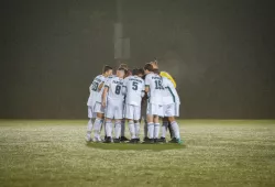 Soccer players huddle