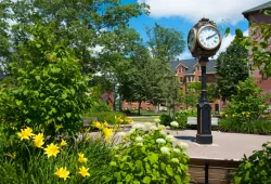 The clock at the centre of UPEI's campus surrounded by summer foliage