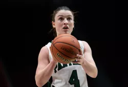 A female basketball player prepares for a foul shot