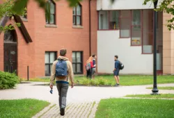 Photo of student walking in quad