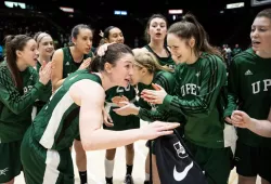 A group of female basketball players congratulating each other after a game