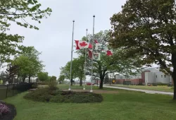 Image of the flags in front of Kelley Memorial Building at half mast