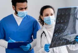 photo of health workers looking at x-ray