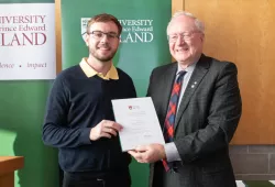 Award winner Bailey Clark accepts his certificate from President Emeritus Wade MacLauchlan