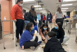 Claire Graham, AVC Vet Camp Coordinator and doctor of veterinary medicine student, teaches participants about small animal physical examinations.