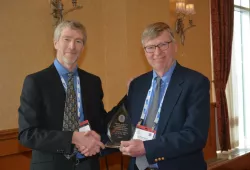 Dr. Gary Conboy receives the Atlantic Award of Excellence in Veterinary Medicine and Animal Care from Dr. John VanLeeuwen, interim dean, AVC, in 2022. 