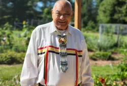 photo of Indigenous man wearing traditional Mi'kmaq regalia