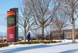 photo of sign in front of UPEI campus during winter