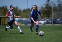 New Panther recruit Olivia James (right) surveys the field before clearing the ball to safety.