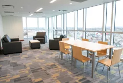 photo of room with tables and chairs with lots of windows